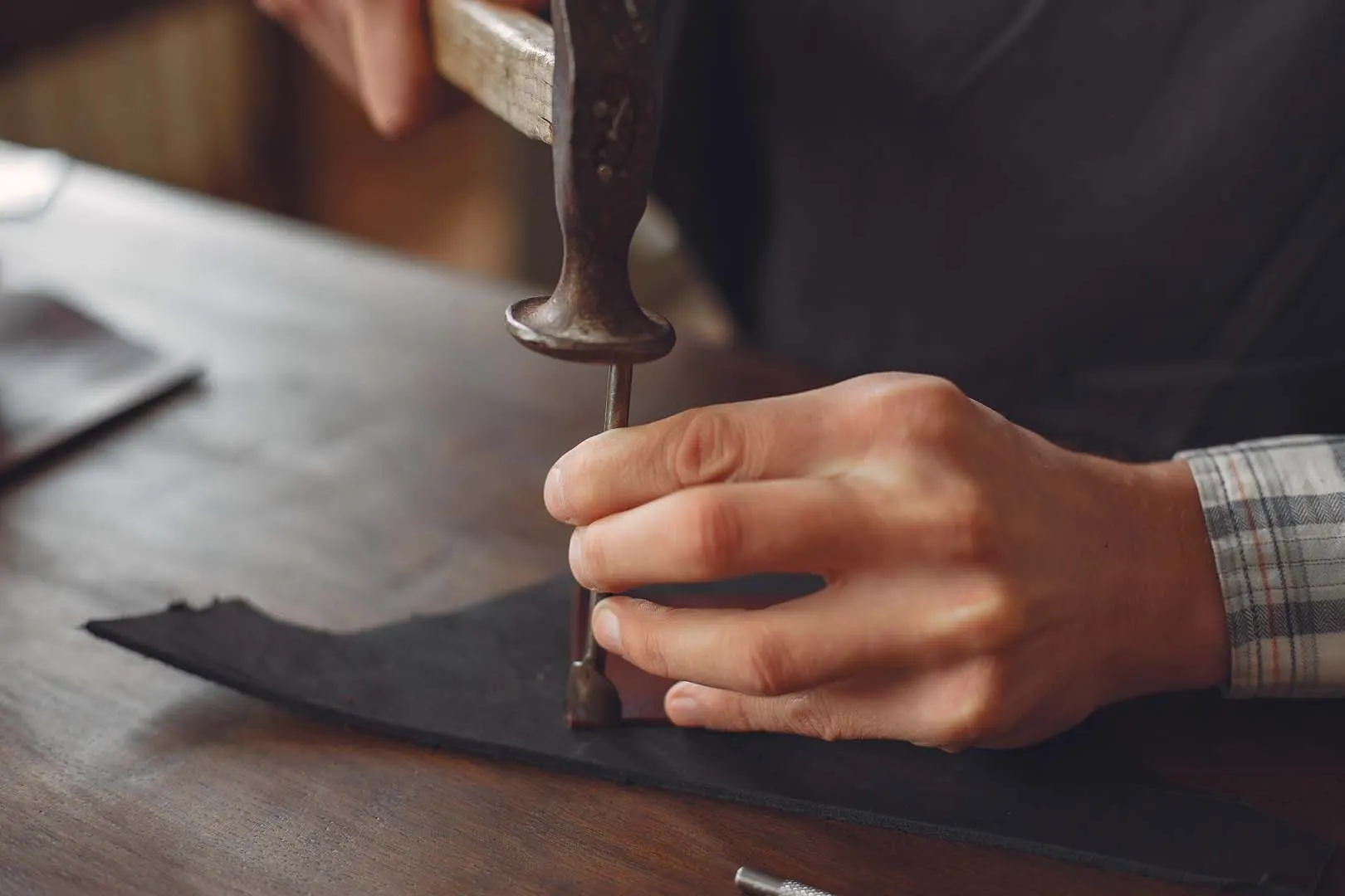 Leathermend master craftsman working leather ware in the Halifax workshop