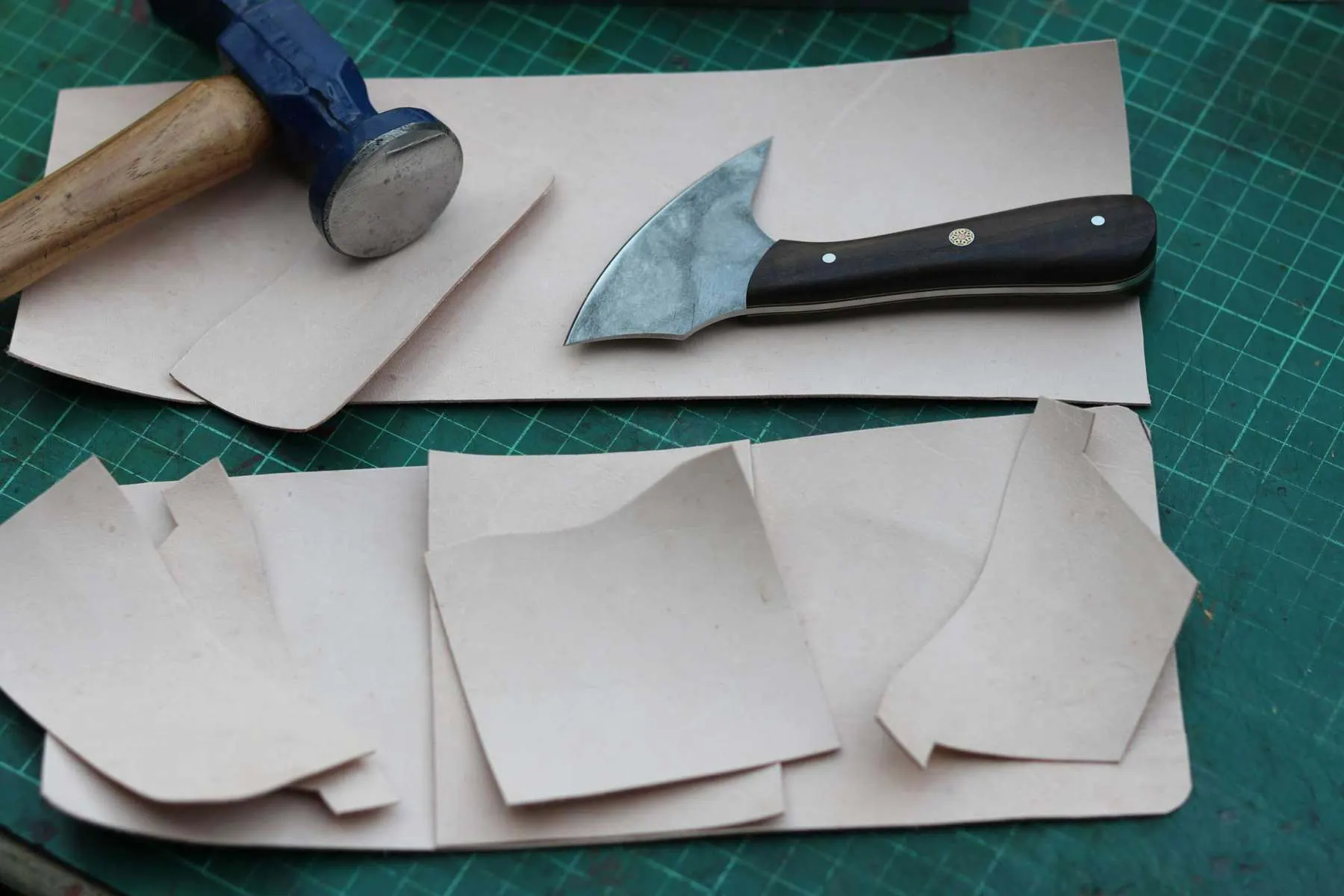 Craftsman hand cutting leather at the Leathermend workshop